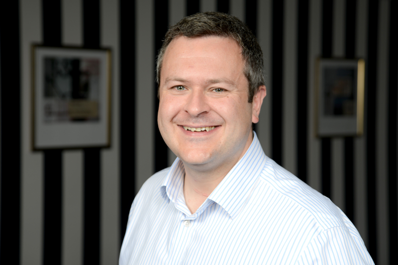 Stuart Brown, a Director of Duncan & Toplis, wearing a white shirt and smiling