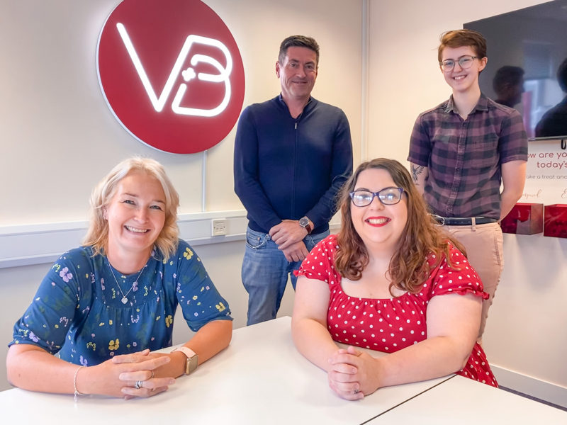 Four people in Visual Print and Design's office - Cassandra Taylor, Graham Grant, Rachael Hunt, Kye Sparks