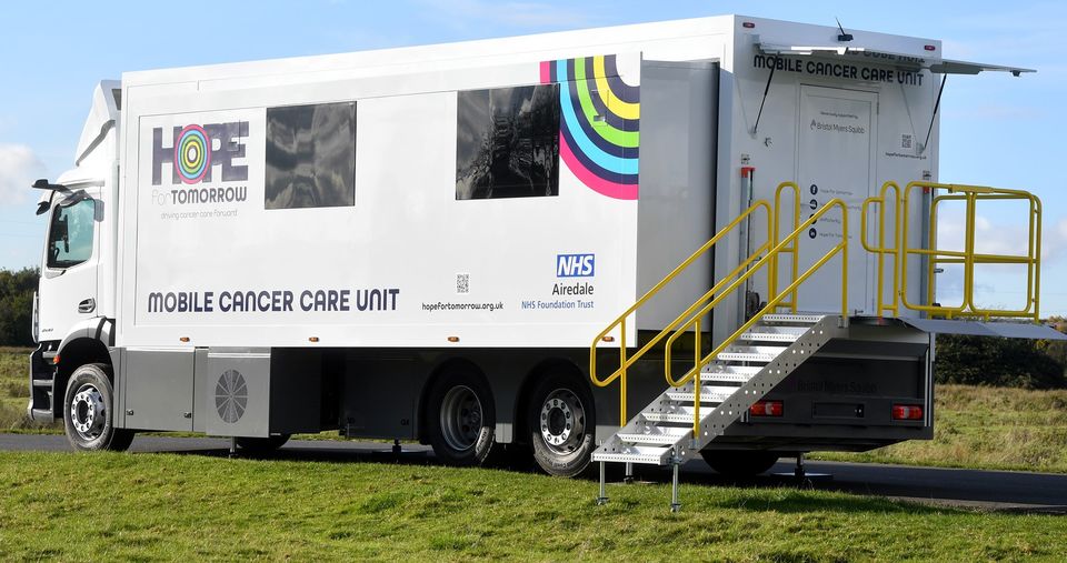 A large white container, with a Hope for Tomorrow logo on the side. This is one of the mobile cancer care units the charity has to help patients across the country get vital help.