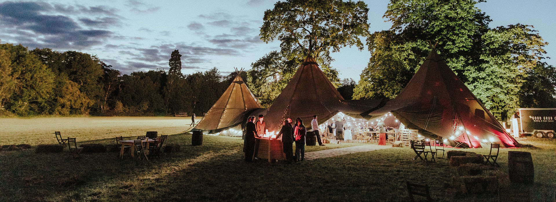 An outdoor image in a field of a tipi wedding venue.